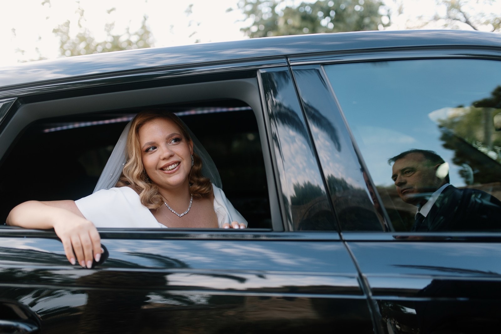 Happy bride arriving at wedding venue